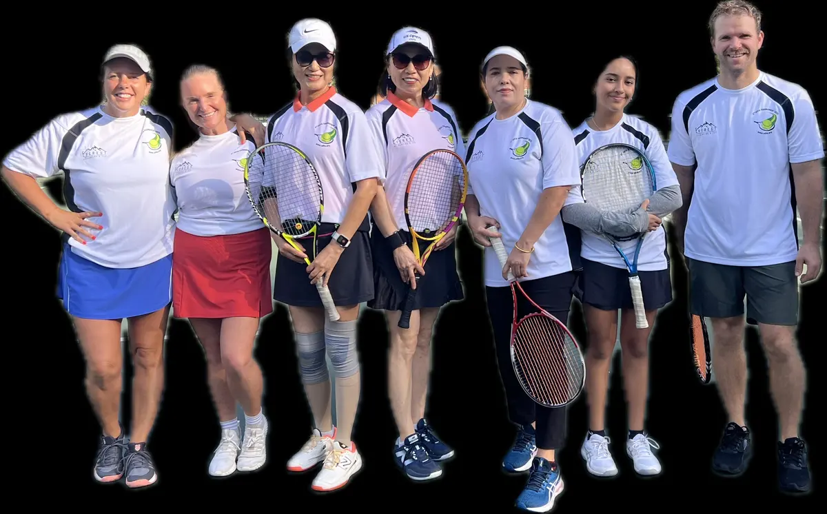 A group of women in matching UDTA tournament shirts pose with their racquets.